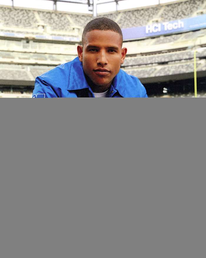 Darren Waller models New York Giants apparel.